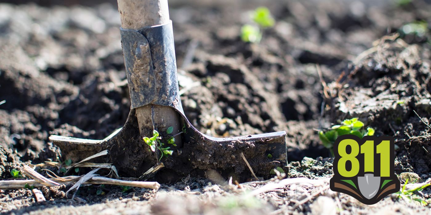 Shovel in dirt with 811 logo